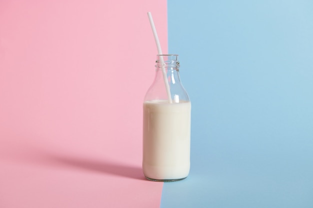 Studio shot of bottle with fresh milk with straw