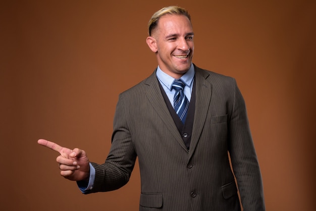 Studio shot of businessman on brown