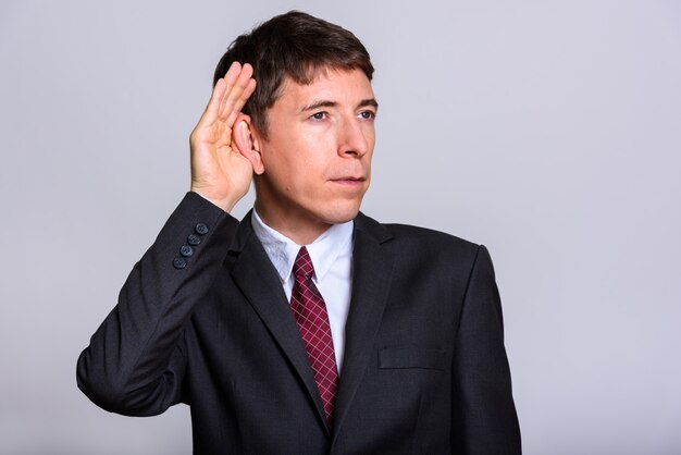 Studio shot of Caucasian businessman standing isolated against white background