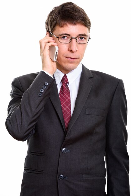 Studio shot of Caucasian businessman standing isolated against white background