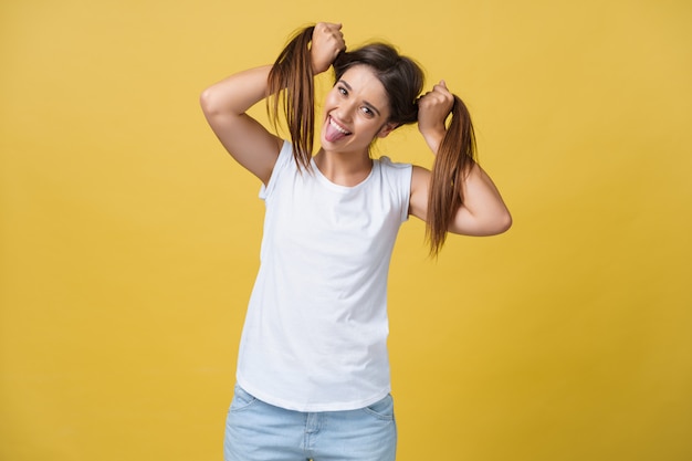 Studio shot of charming caucasian girl isolated on yellow background.