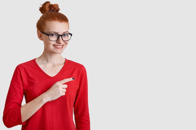 Studio shot of cheerful woman with red hair bun