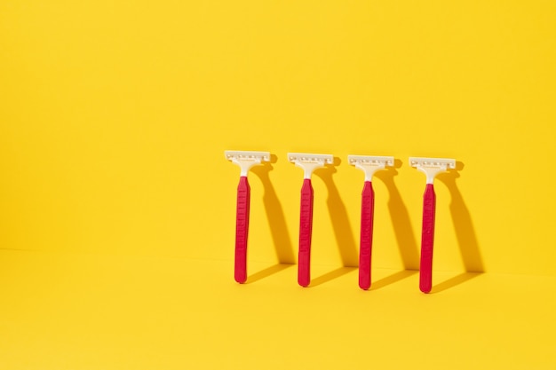 Studio shot of disposable razor tools on yellow background
