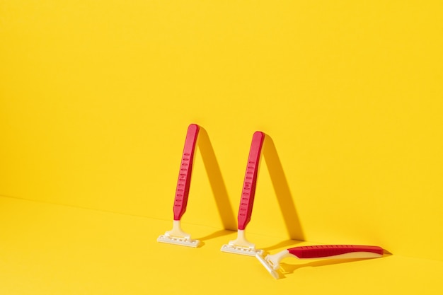 Studio shot of disposable razor tools on yellow