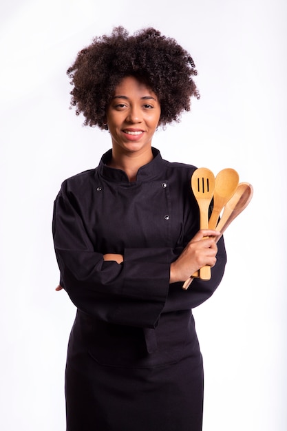 Studio shot of a female chef with a wooden spoon