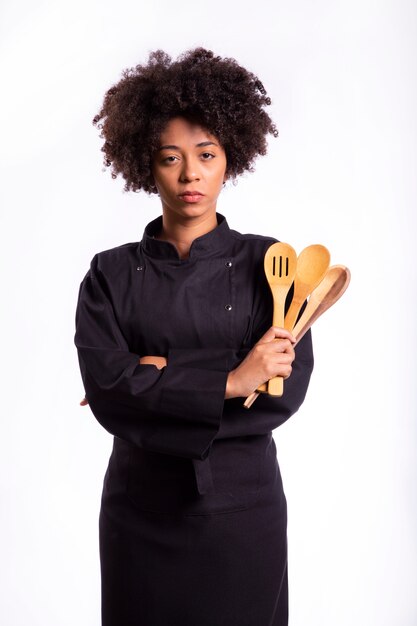 Studio shot of a female chef with a wooden spoon