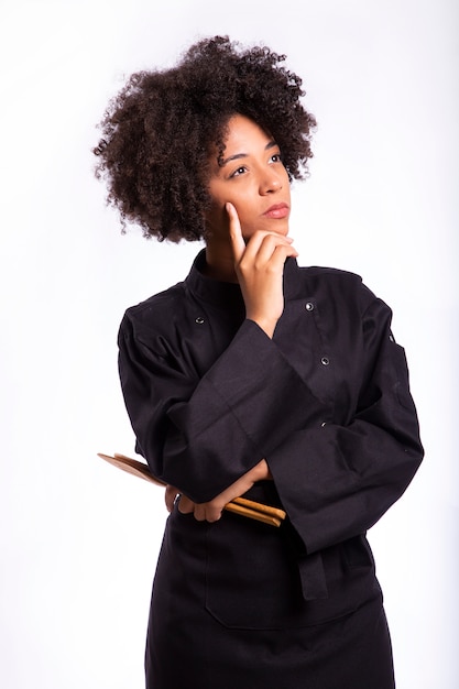 Studio shot of a female chef with a wooden spoon