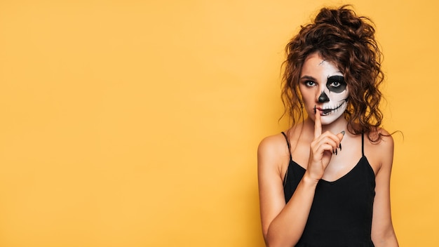 Studio shot of a girl in a costume of evil spirits at a Halloween costume party. A place for your text for products, advertising. The Art of Halloween.