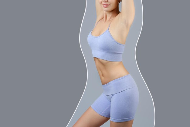 Photo studio shot of a girl in lilac shorts and a tank top showing off her slim figure