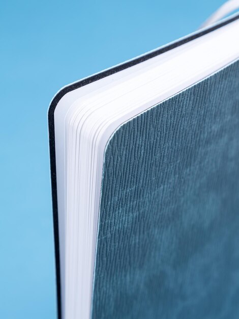 Studio shot of a gray corner of a hardcover notebook closeup