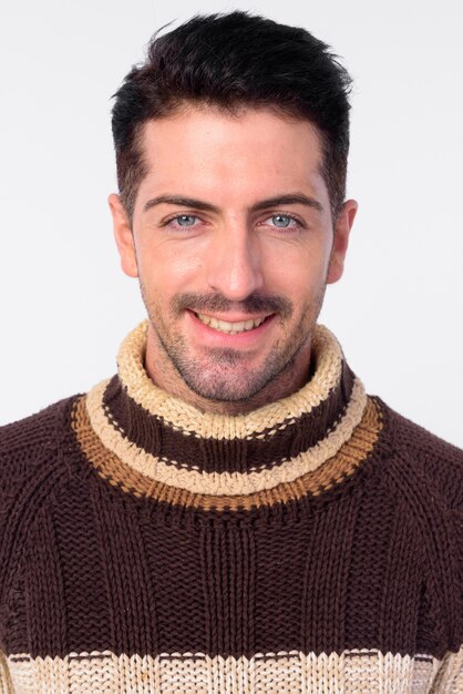 Studio shot of handsome bearded man ready for winter isolated against white background