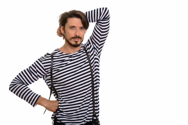 Studio shot of handsome man posing with hands on head and hip