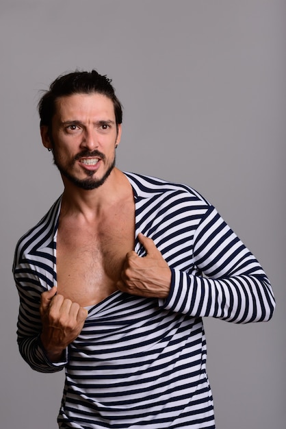 Studio shot of handsome man showing chest