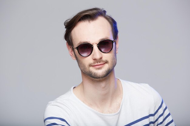 Studio shot of handsome man wearing sunglasses