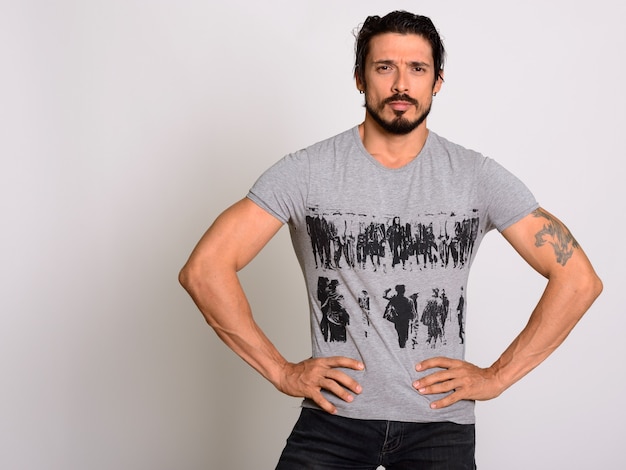 Studio shot of handsome muscular man posing with hands on hips
