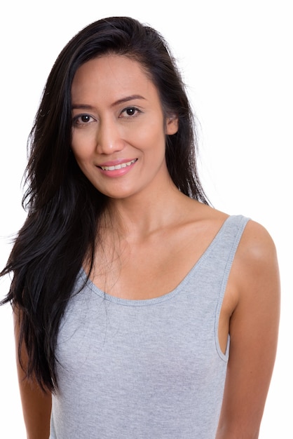 Studio shot of happy beautiful Asian woman smiling