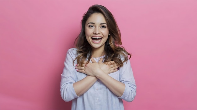 Photo studio shot of happy cute young woman folds arms on chest expresses gratitude swears or promises