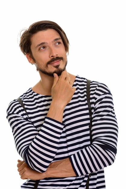 Studio shot of happy handsome man smiling and thinking