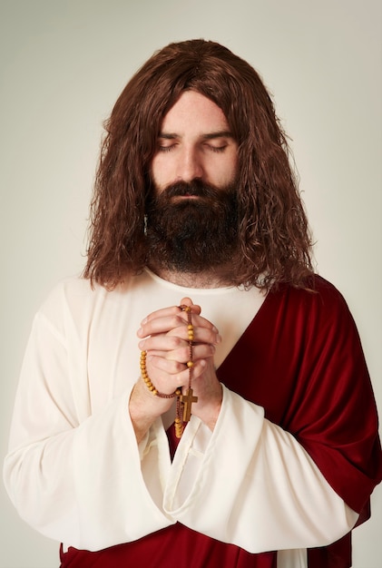 Studio shot of Jesus with rosary