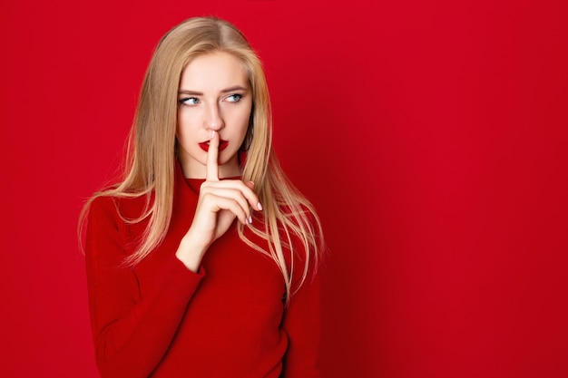 A studio shot of longhair blone girl wears casual red t-shirt