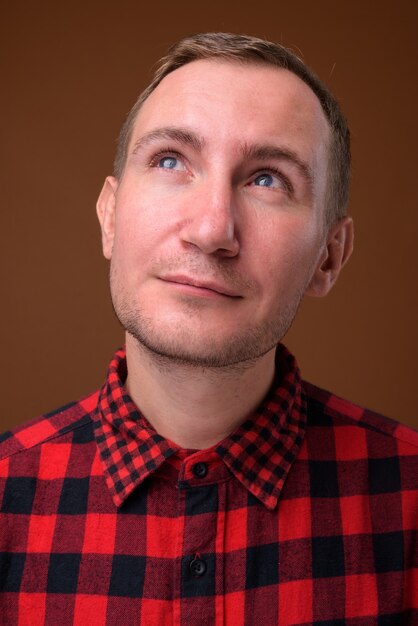 Studio shot of man on brown