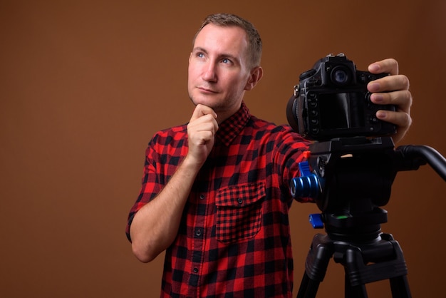 Studio shot of man on brown