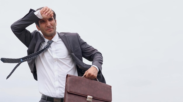 Studio shot of a mature businessman running with a briefcase