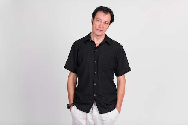 Studio shot of mature handsome man against white