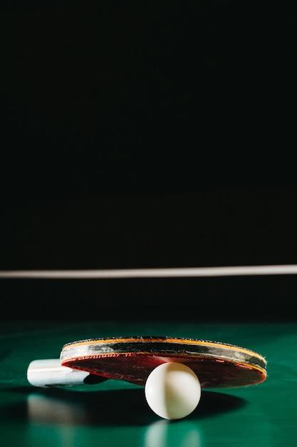 Studio shot of ping pong racket leaning on ping pong ball