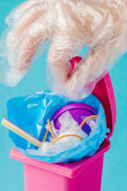 Studio shot of a pink big trash on blue background