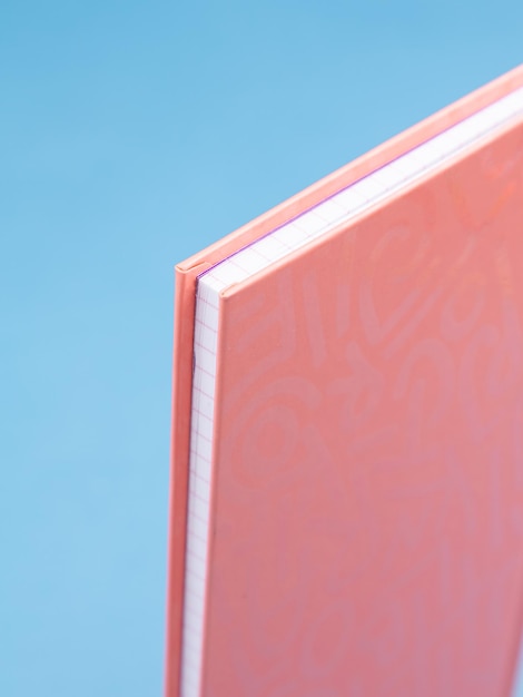 Photo studio shot of a pink corner of a hardcover notebook closeup