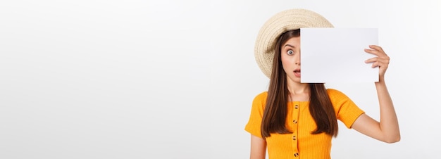 Studio shot of a shocked woman looking at the bills in disbelief isolated on white background