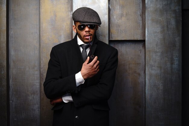 Studio shot of stylish man wearing a coat