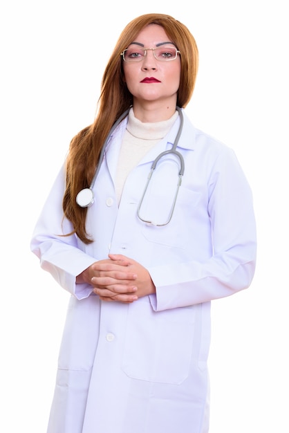 Studio shot of woman doctor standing with hands together isolated against white background