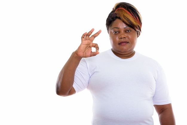 Studio shot of woman giving ok sign