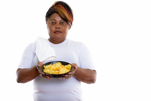 Studio shot of woman holding bowl of potato