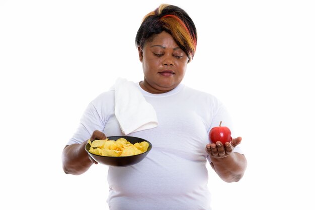 Studio shot of woman holding bowl of potato