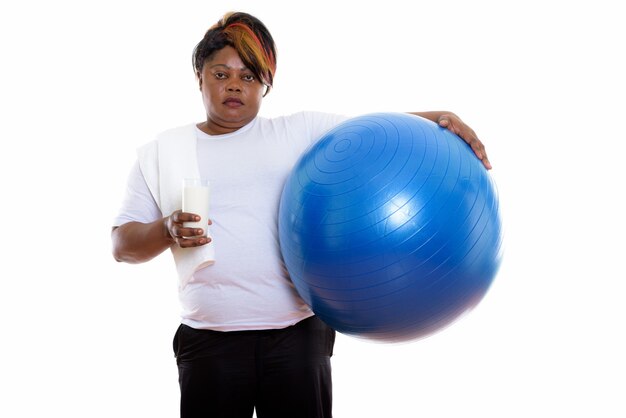 Studio shot of woman holding exercise ball