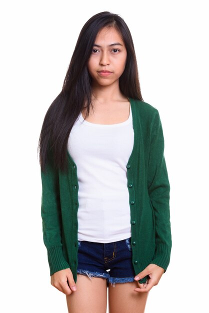 Studio shot of young Asian teenage girl standing