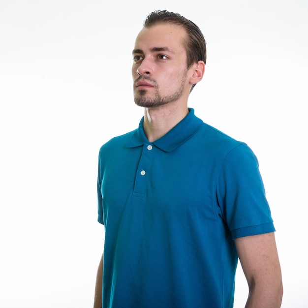 Studio shot of young bearded man against white background