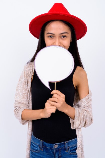 Studio shot of young beautiful Asian woman against white background