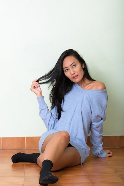 Studio shot of young beautiful Asian woman