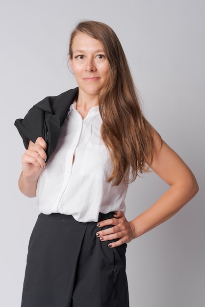 Studio shot of young beautiful businesswoman against white