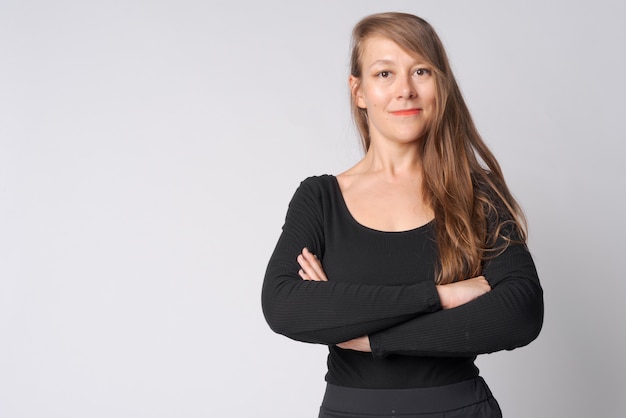 Studio shot of young beautiful businesswoman against white