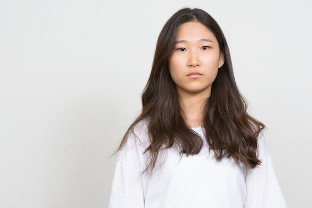 白い背景の若い美しい韓国人女性のスタジオショット