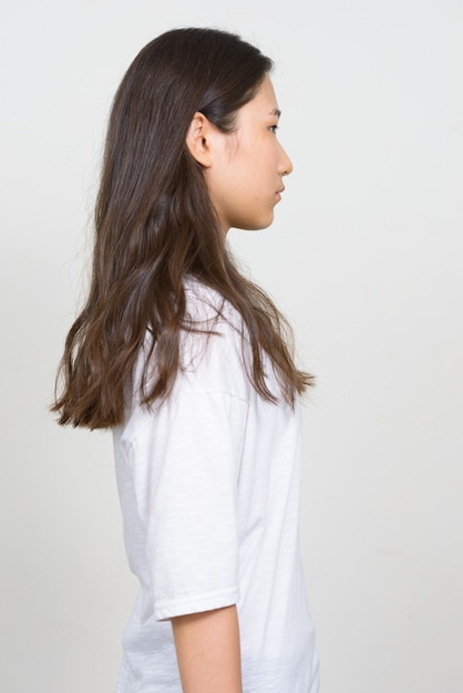 Studio shot of young beautiful Korean woman against white background