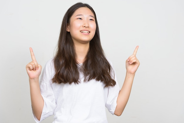 Studio shot of young beautiful Korean woman against white background