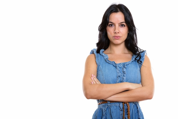 Studio shot of young beautiful Spanish woman with arms crossed