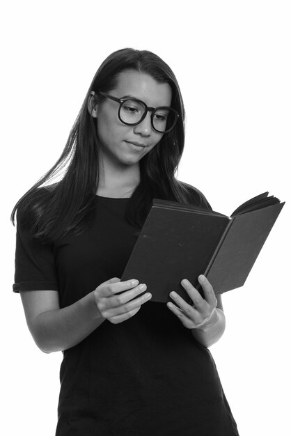 Studio shot of young beautiful woman isolated against white background in black and white