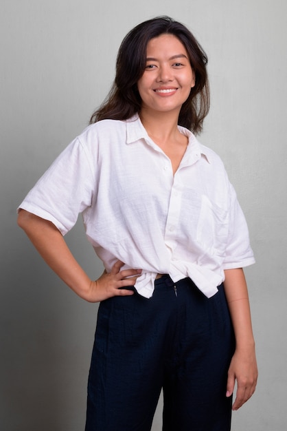 Studio shot of young beautiful woman with short hair against white